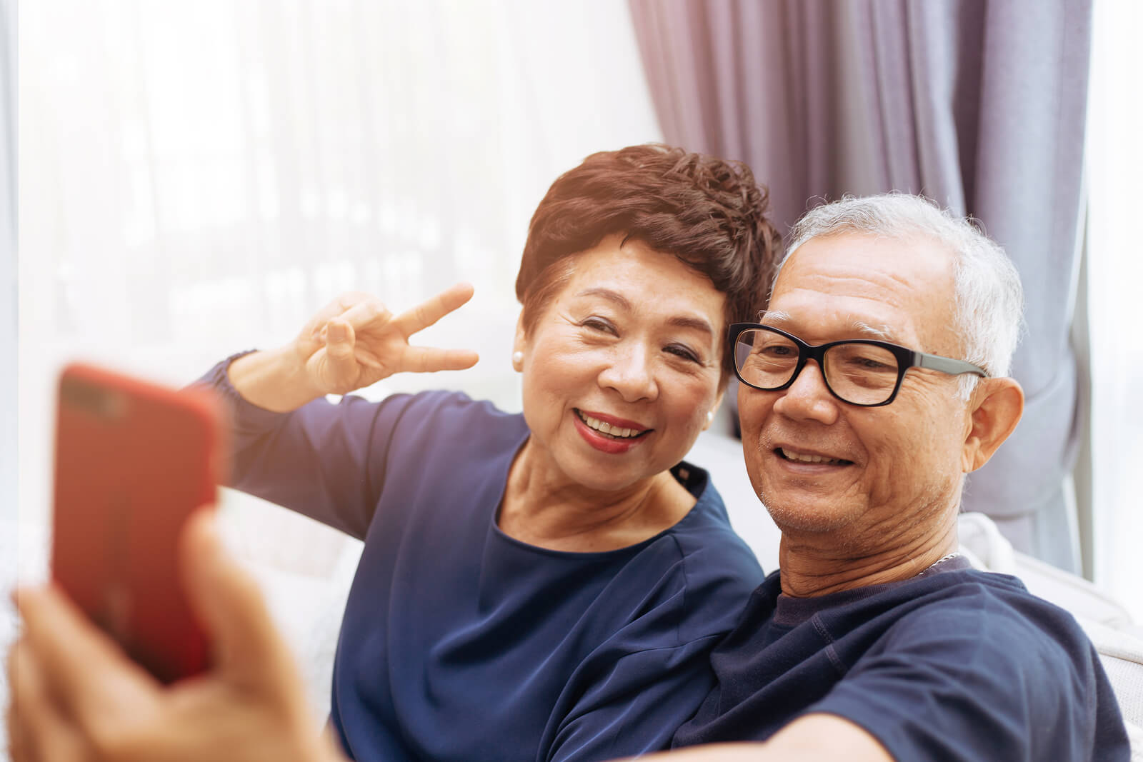Elderly Couple Smiling taking a photo together