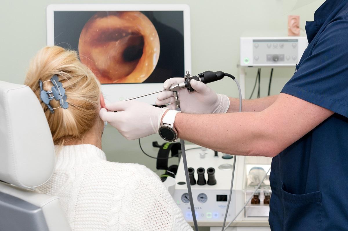 Otolaryngologist doing otitus examination, video otoscopy procedure