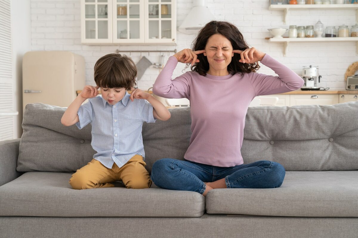 Mother and child plugging ears